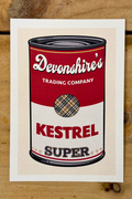 A pop-art style illustration of a soup can, mimicking the classic Campbell's design. The top half is red with "Devonshire's Trading Company" in white script. The bottom half is white with the word "KESTREL" in large red block letters and "SUPER" in gold-outlined letters below it. In the centre is a circular logo featuring a tan and black plaid pattern.